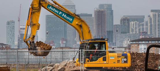 Convoys Wharf - excavator on site with city view in background