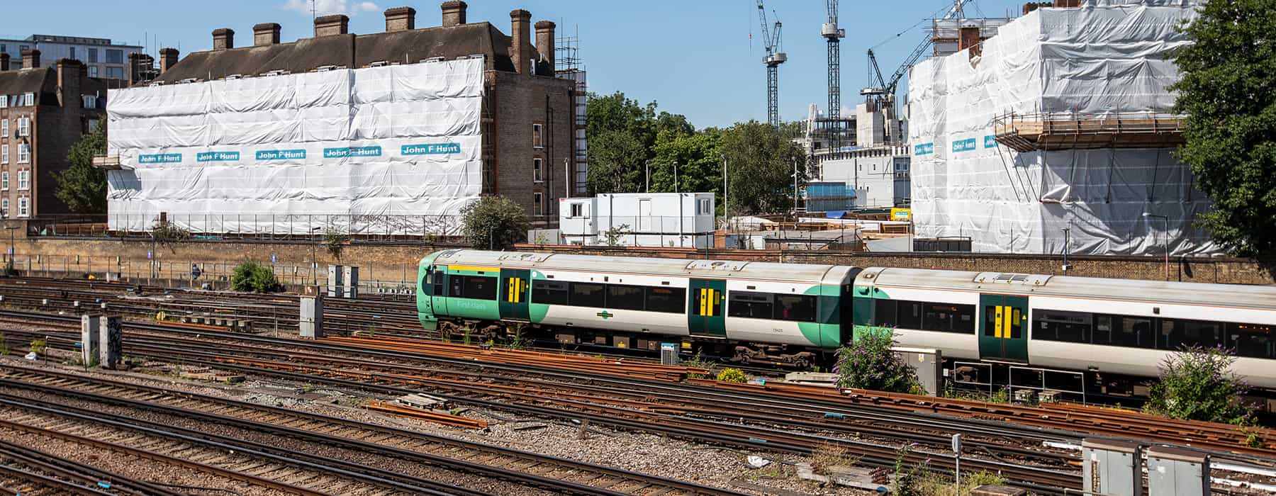 John F Hunt Rail John F Hunt building site in background of train on tracks